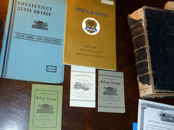 <b>Figure 2.</b> Close-up of Bible, artifact booklets, and annual event brochures